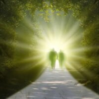 Zwei Personen gehen auf einem Weg zum Licht